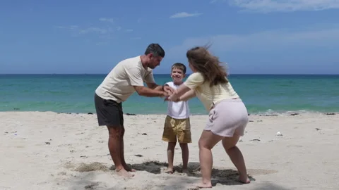 The family does a team hand stack on seaside. Stock Footage 310935120