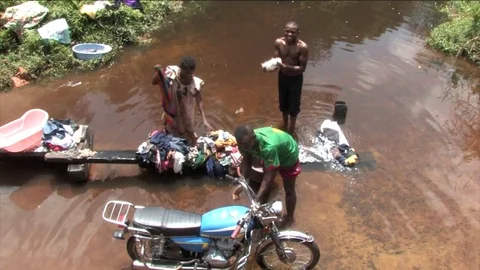 Family doing laundry at the pond Stock Footage 80462283