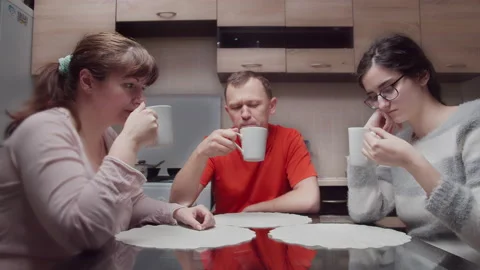 Family drink tea in the evening at the same time, simultaneously bring glasses Video stock 147959683
