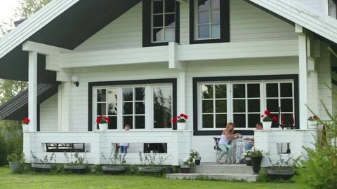 Family drinking tea in the backyard Video stock 82020033