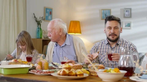 Family Eating and Talking at Easter Dinner Stock Footage 106630757
