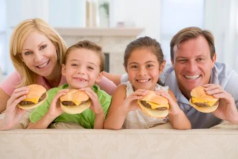 Family eating cheeseburgers together Stock Photos