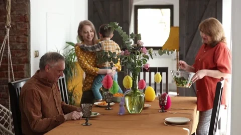 Family eating at Easter dinner sitting at the table at home Stock Footage 172528740