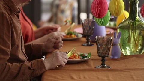Family is eating at Easter dinner sitting at the table at home Video stock 172528746