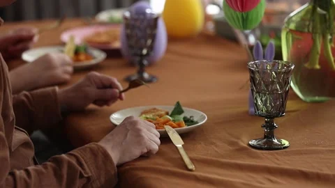 Family is eating at Easter dinner sitting at the table at home Stock Footage 172528774
