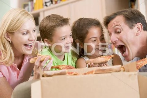Family eating pizza together Stock Photos
