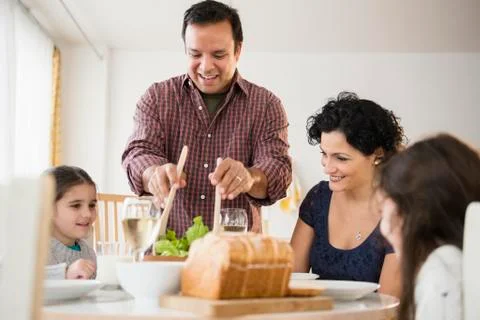 Family eating together at table Stock Photos