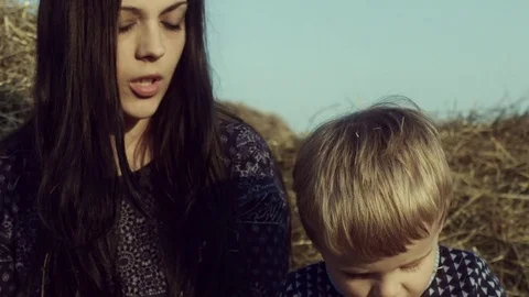 The family eats apples in a haystack in the field. Stock Footage 84187003