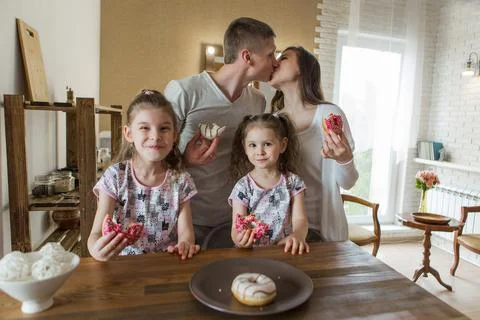 The family eats cakes. dinner at the bakery. feast in the kitchen. the butche Stock Photos