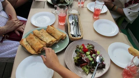 Family eats lunch in a restaurant, table, drinks, summer Stock Footage 94485349