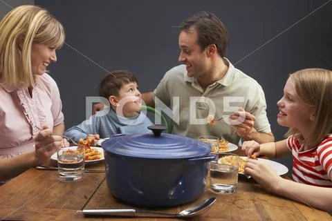 Family Enjoying Meal Together At Home Stock Photos