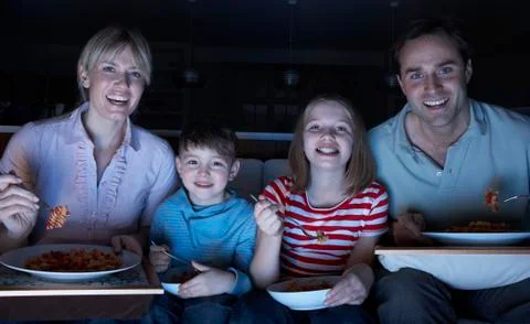 Family Enjoying Meal Whilst Watching TV Stock Photos
