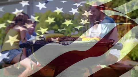 Family enjoying a picnic and the American flag for fourth of July. Stock Footage