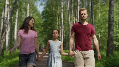 Family enjoying talking while walking together Stock Footage 133608049