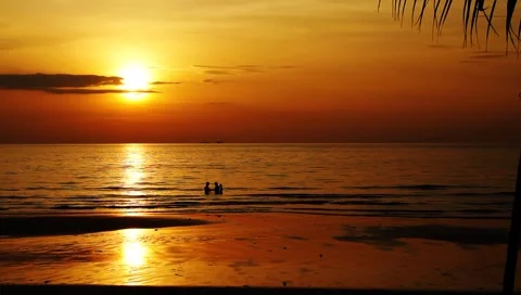 Family enjoying time in calm ocean on exotic tropical beach at beautiful sunset Stock Footage
