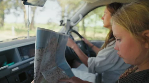 Family explores new places while driving and looking at a map Stock Footage 335065165