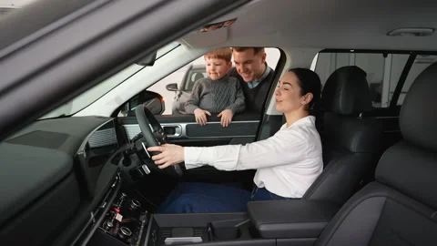Family exploring features of a new right-hand drive car Video stock 303384936