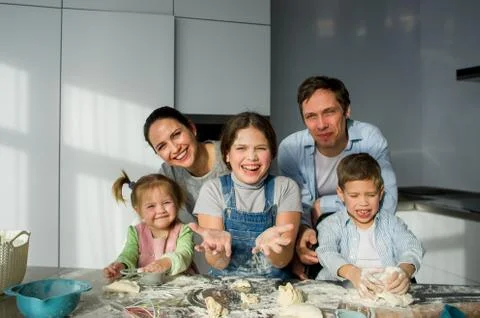 A family of five in the kitchen Stock Photos