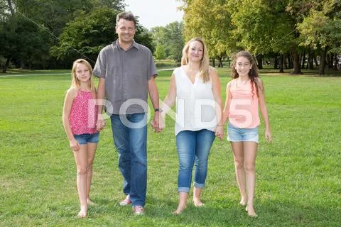 Family of four, mother, father and two girls Stock Photos