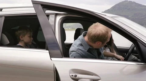 Family gets in a car with their dog and continue to ride Stock Footage