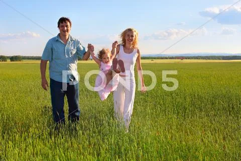 Family going across the field Stock Photos