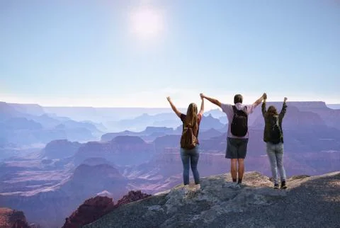 Family with hands up enjoting time together on hiking trip. Stock Photos