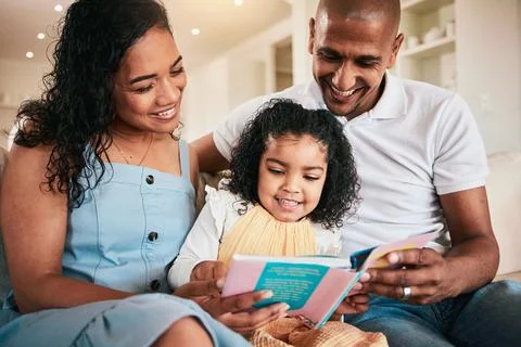 Family, happy and child reading story book, cartoon comic books and bonding with Stock Photos
