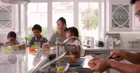 Family Having Breakfast And Making Lunches Shot On R3D Stock Footage