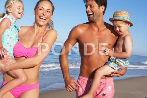 Family having fun on beach Stock Photos