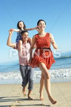 Family having fun on beach Stock Photos