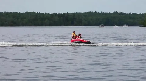 Family having fun being pulled on tube Stock Footage 52191403