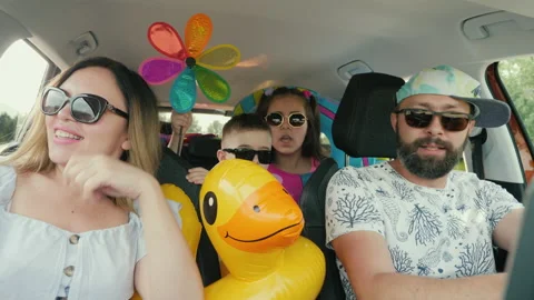 Family having fun dancing sing songs while traveling by car on summer vacation Stock Footage 156495216