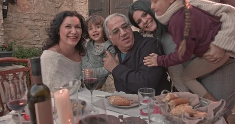 Family having fun with grandparents at family meal Stock Footage