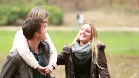 Family having fun in park, father giving daughter piggyback ride Stock Footage 59554422