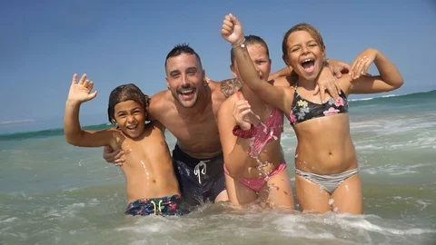 Family having fun in the waves Stock Footage 115545234