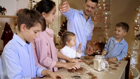 Family is having fun while bakes a cookies at home kitchen Stock Footage 122636271