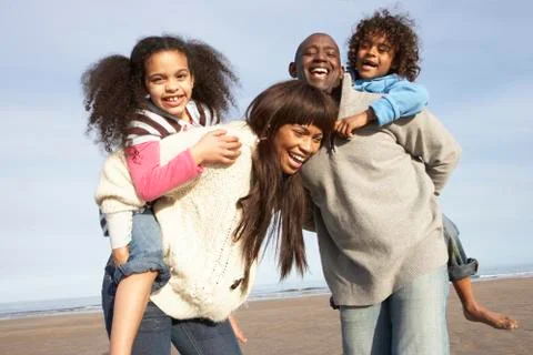Family having fun on winter beach Stock Photos