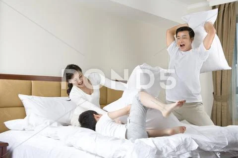 Family having pillow fight Stock Photos
