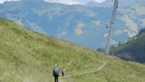 Family hikes down path in Austrian Alps in Summer Stock Footage 148177506