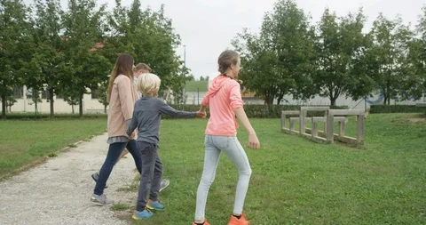 Family Holding Hands While Walking At Playground Stock Footage 125305430