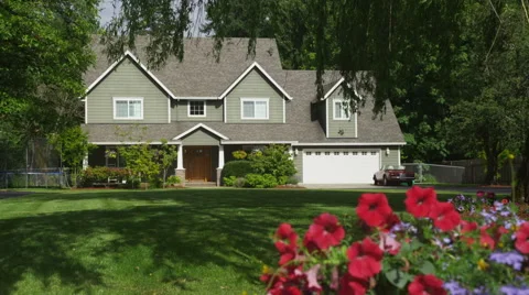 Family home with spring flowers, dolly movement Stock Footage