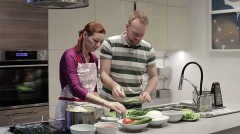Family in the kitchen preparing dinner Stock Footage 62781148