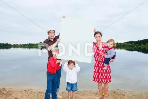 Family By Lake, Holding A Blank Sign