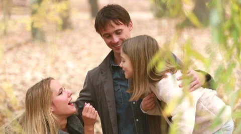 Family laughing and talking in park Stock Footage 59554446