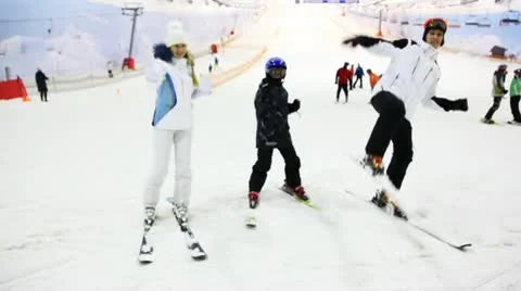Family with little boy show martial arts on ski in snow Stock Footage