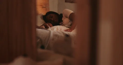 Family with little kid sleeping in bed in the morning Stock Footage