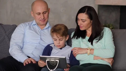 Family is looking at a tablet computer Stock Footage 88322187