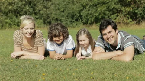 Family lying on grass Stock Footage 22637341
