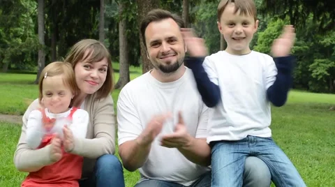 Family (middle couple in love, cute girl and small boy) together clap one's hand Stock Footage
