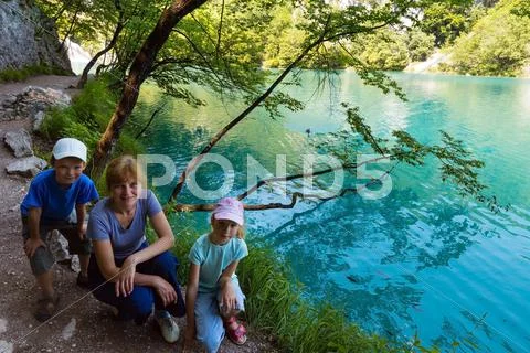 Family near summer azure limpid transparent lake (plitvice, croatia) Stock Photos